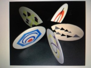 an overhead shot of a star or flower shaped 3 dimensional paper structure